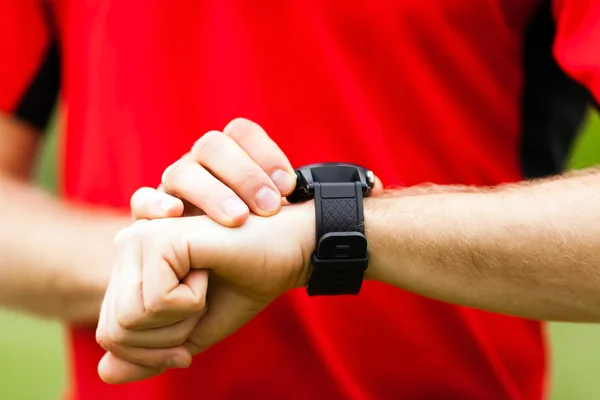 Runner looking at sport watch — Stock Photo, Image