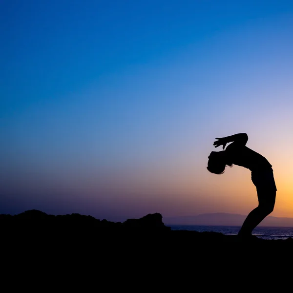 Woman doing yoga sunset silhouette — Stock Photo, Image