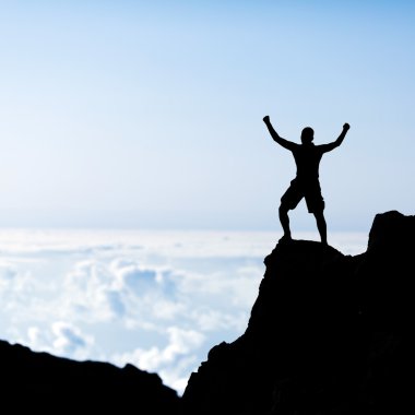 Success man silhouette, climbing in mountains clipart
