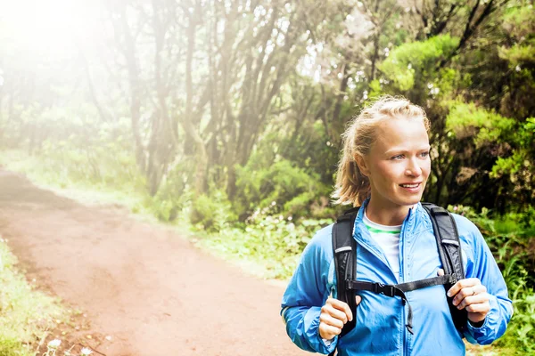 Woman hiker or trail runner in green forest — Stock Photo, Image