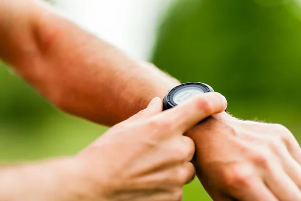 Trail runner looking at sport watch — Stock Photo, Image