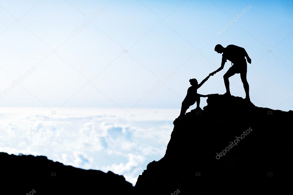 Man and woman help silhouette in mountains