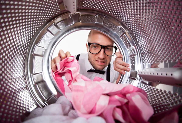 Young man doing laundry View from the inside of washing machine — Stock Photo, Image