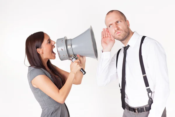 Businesswoman shouting at a businessman with megaphone Stock Image