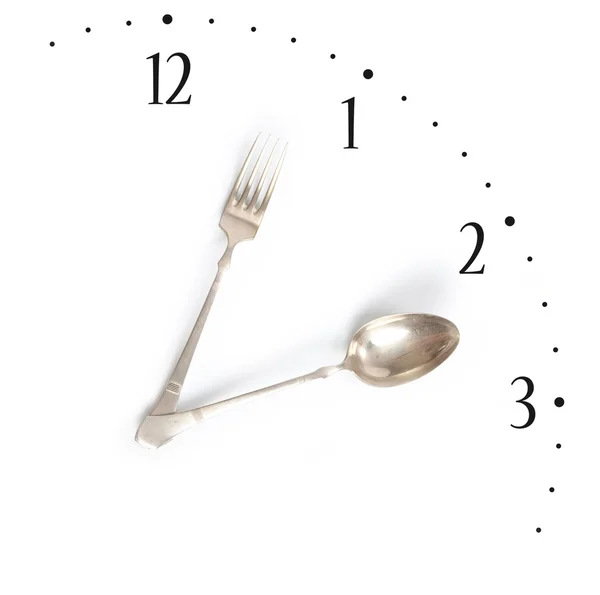 Ora di pranzo, orologio fatto di forchetta e cucchiaio Foto Stock Royalty Free