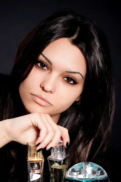 Beautiful brunette woman with perfume — Stock Photo, Image