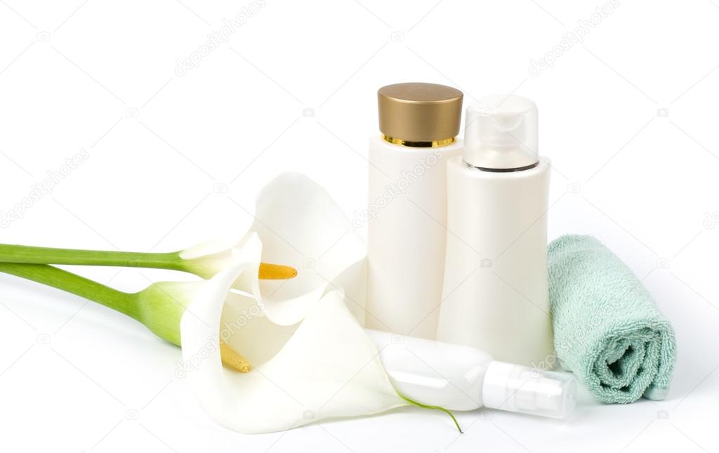 White calla lilies, face cream and a towel