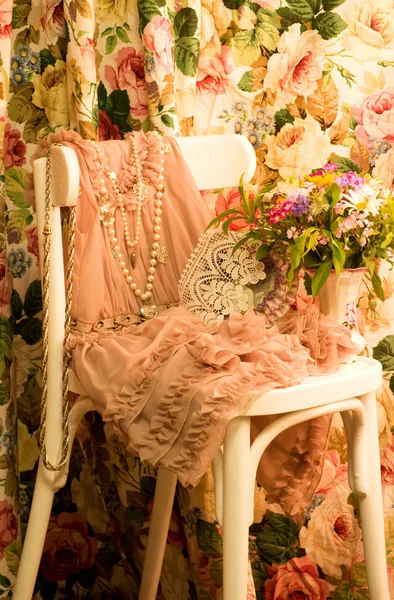 Elegant pink dress on a chair — Stock Photo, Image