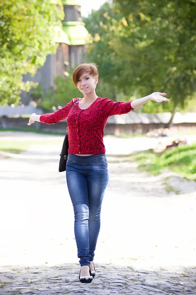 Beautiful young woman in spring garden — Stock Photo, Image