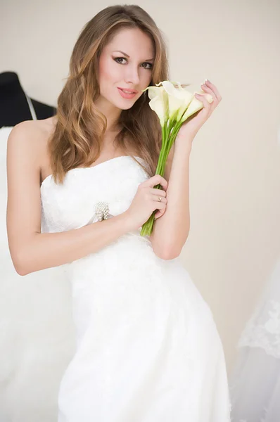 Beautiful bride with stylish make-up in white dress — Stock Photo, Image