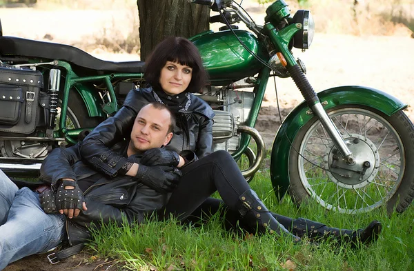 Glückliches Paar in der Nähe eines Motorrads — Stockfoto