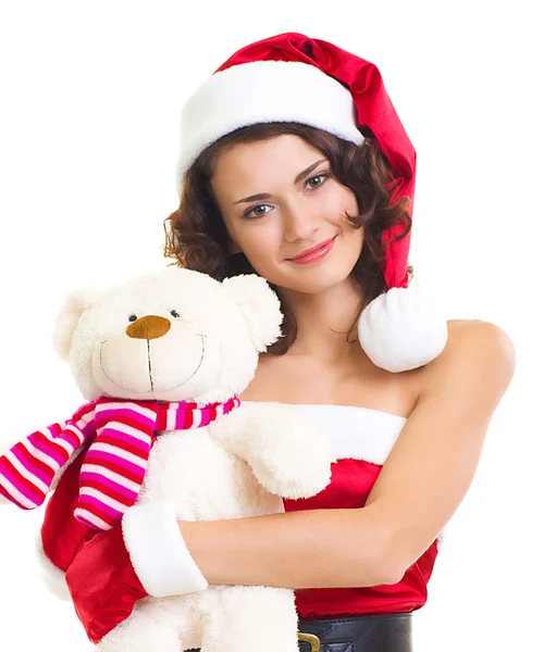 Beautiful young woman in Santa Claus clothes with toy dog on white background. — Stock Photo, Image