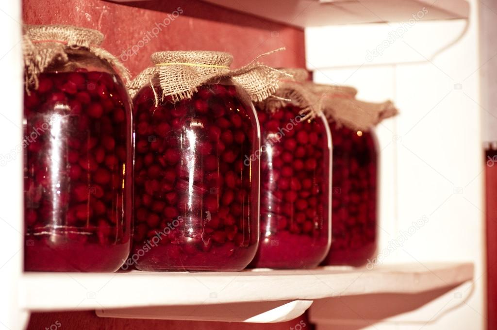 Jars with cherry compotes