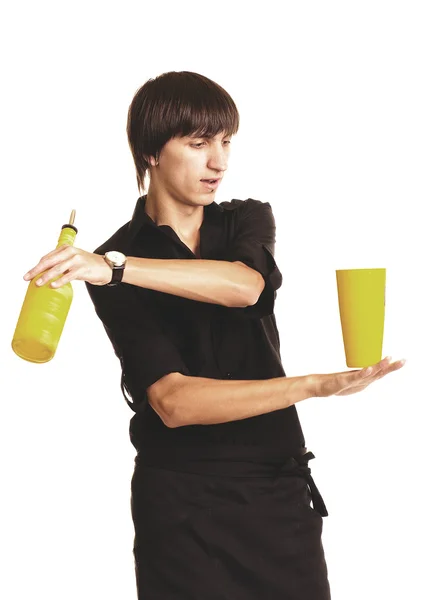 Jeune barman avec un shaker et une bouteille sur fond blanc — Photo