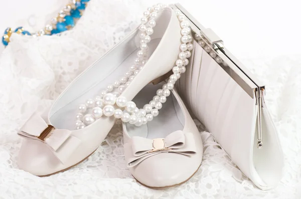 The bridal shoe, flowers and beautiful jewelry Stock Photo