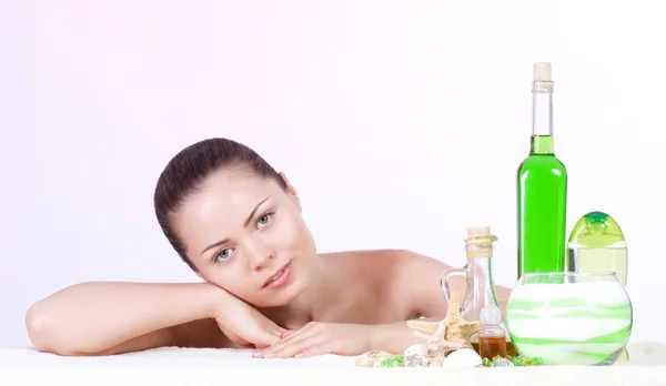 Beauty young woman with spa oils — Stock Photo, Image