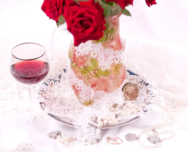 Belle rose rosse in vaso con bicchiere di vino — Foto Stock