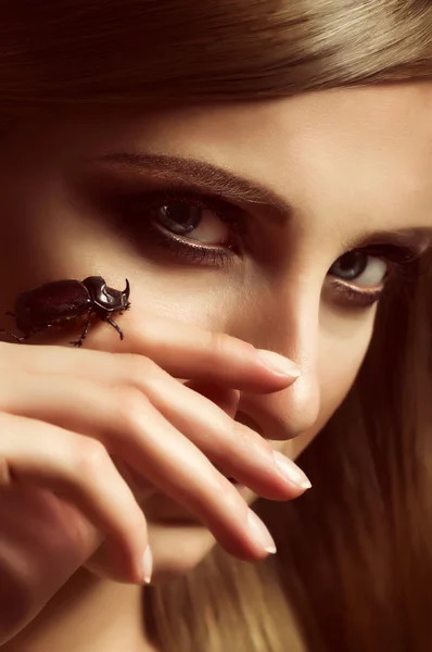 Portrait of beautiful young woman with beetle — Stock Photo, Image