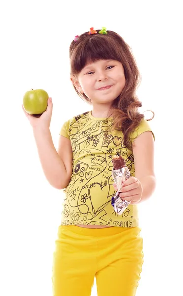 Menina bonita com maçã e chocolate no fundo branco — Fotografia de Stock