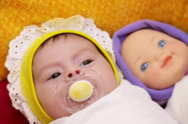 Cute funny infant baby with doll — Stock Photo, Image