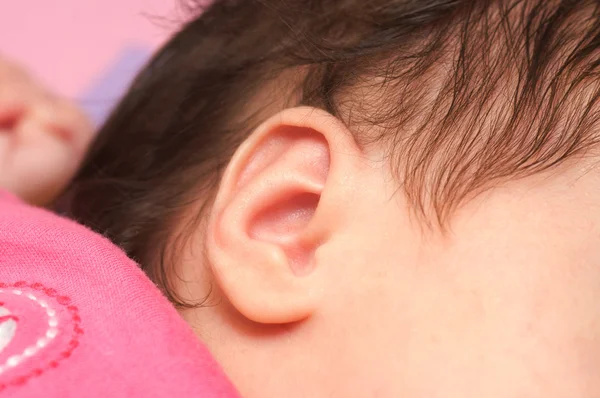 Cerca de la oreja de un bebé dormido — Foto de Stock