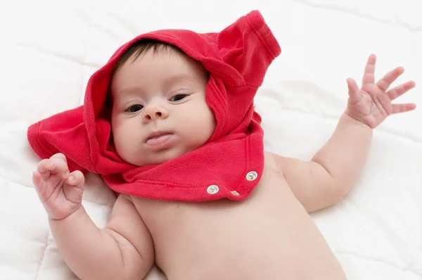 Picture of a beautiful baby girl in red cloth — Stock Photo, Image