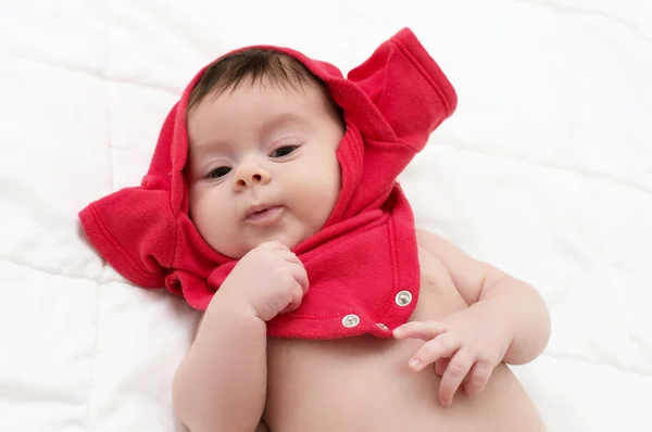 Picture of a beautiful baby girl in red cloth — Stock Photo, Image