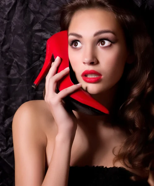 Woman imitates phone with heel — Stock Photo, Image