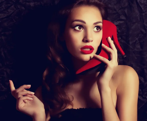 Woman imitates phone with heel — Stock Photo, Image