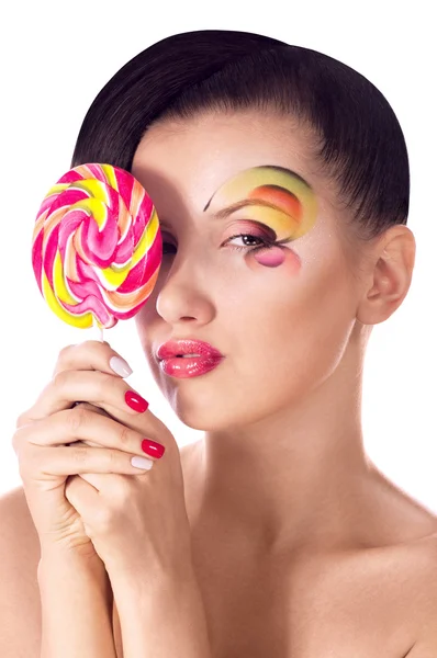 Beautiful young girl with pink spiral lollipops — Stock Photo, Image