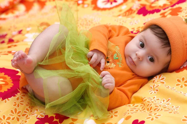 Cute little girl in orange clothes — Stock Photo, Image