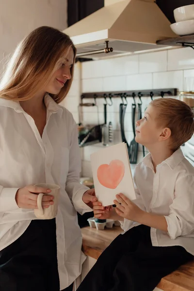 Happy Little Boy Congratulating Smiling Mother Giving Card Red Heart — Stock Photo, Image