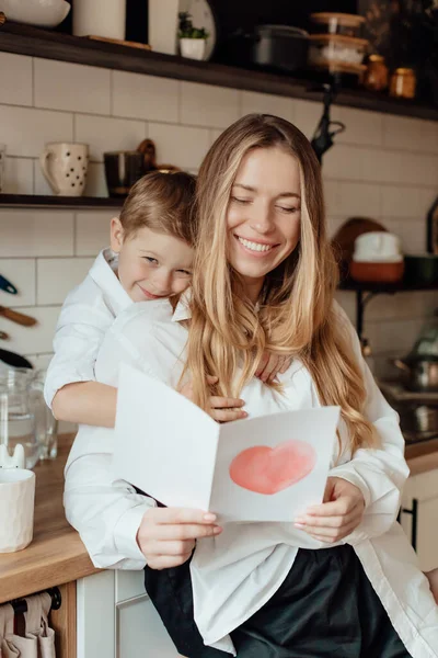 Happy Little Boy Congratulating Smiling Mother Giving Card Red Heart — Stock Photo, Image