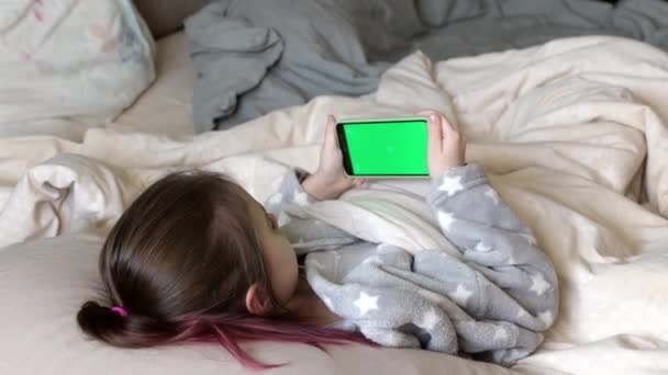 Mała Dziewczynka Trzyma Mobilny Smartfon Chromakey Zielony Ekran Łóżku Koncepcja Klip Wideo