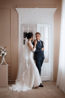 Gelin ve damat, güzel genç bir çift. Şatafatlı bir iç mekan. Düğün günü konsepti