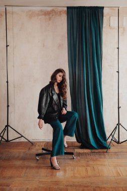 Fashion Portrait of stylish girl. Beautiful model European girl posing in a casual clothes in the studio. Female body and style concept.