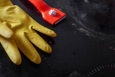 Cam seramikleri temizlemek için kazıyıcı ve cam seramik paneli temizlemek için lastik eldiven.