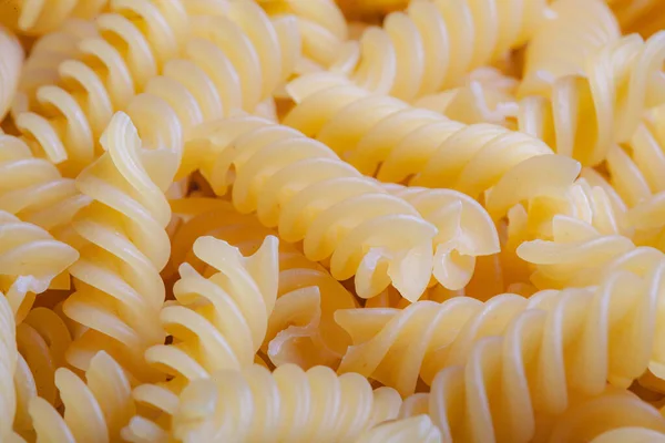 Close up raw italian Pasta spiral background selective focus Stock Fotó