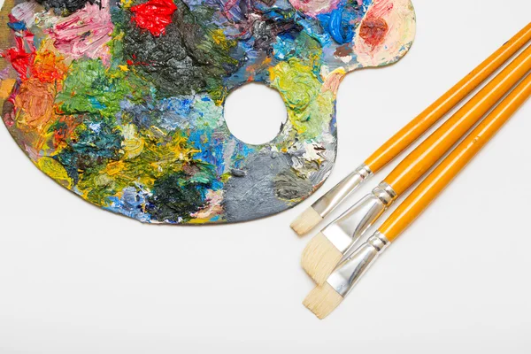 Pallette with brushes — Stock Photo, Image