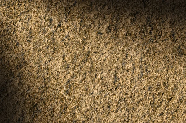 Granito piedra textura iluminada diagonalmente —  Fotos de Stock