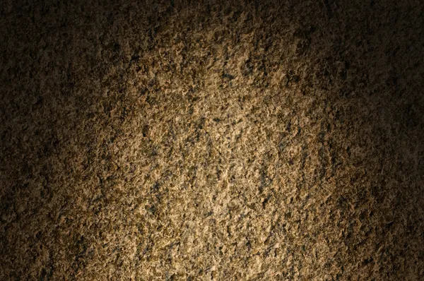 Granite rock stone texture lit dramatically — Stock Photo, Image