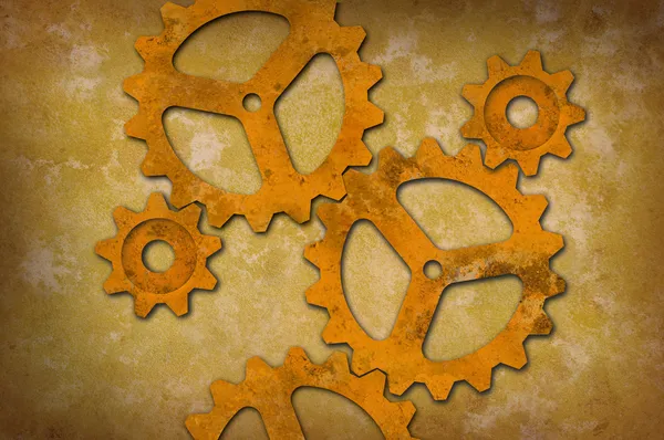 Rusty gears against a mottled yellowish background — Stock Photo, Image