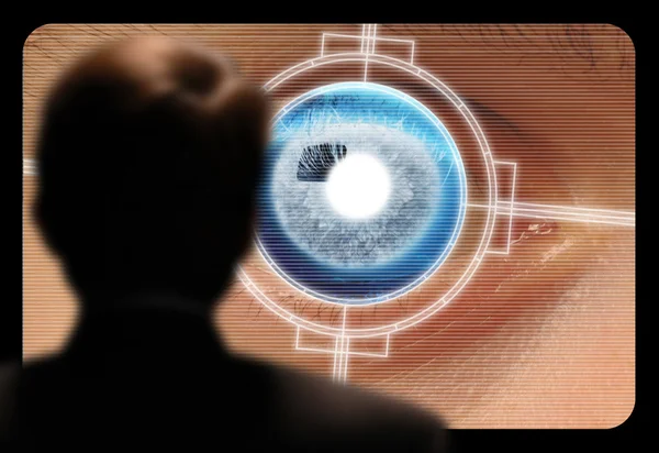 Man viewing a retinal eye scan on a video monitor — Stock Photo, Image