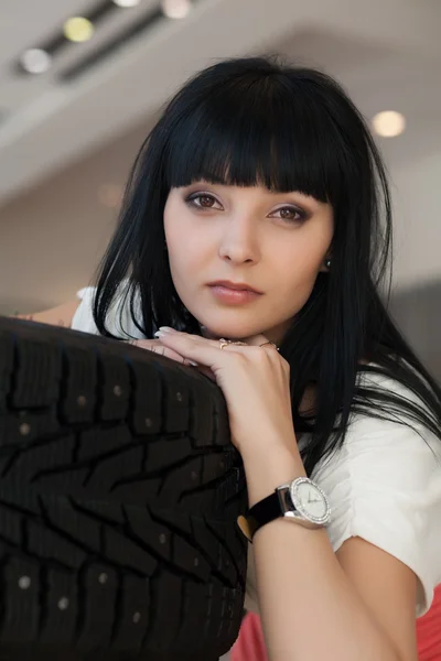 Portrait of a brunette with studded tires — Stock Photo, Image