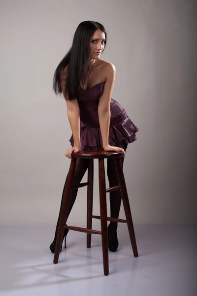 Slender brunette in a short dress — Stock Photo, Image