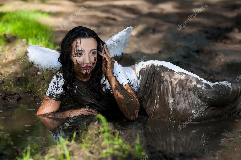 Girl with angel wings lying in the mud Stock Photo by ©MomSirk 18013675