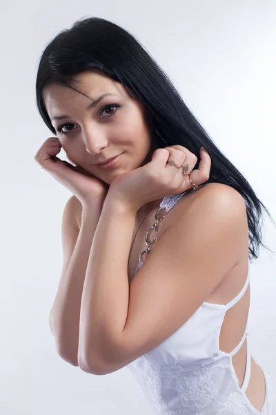 Portrait of a cute brunette on a white background — Stock Photo, Image