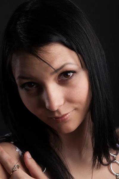 Brunette in a white dress on a black background — Stock Photo, Image