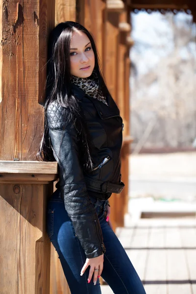 Brunette on the porch of an old wooden house — Stock Photo, Image