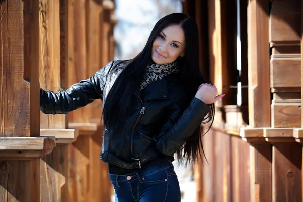 Brunette on the porch of an old wooden house — Stock Photo, Image